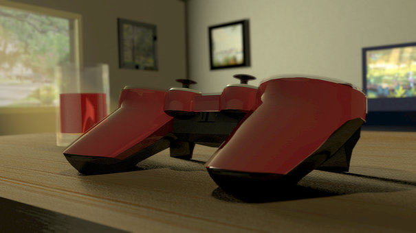 A shiny red controlled, on top of a table, during the day. Sun is shining through a window further on the left side of the image.