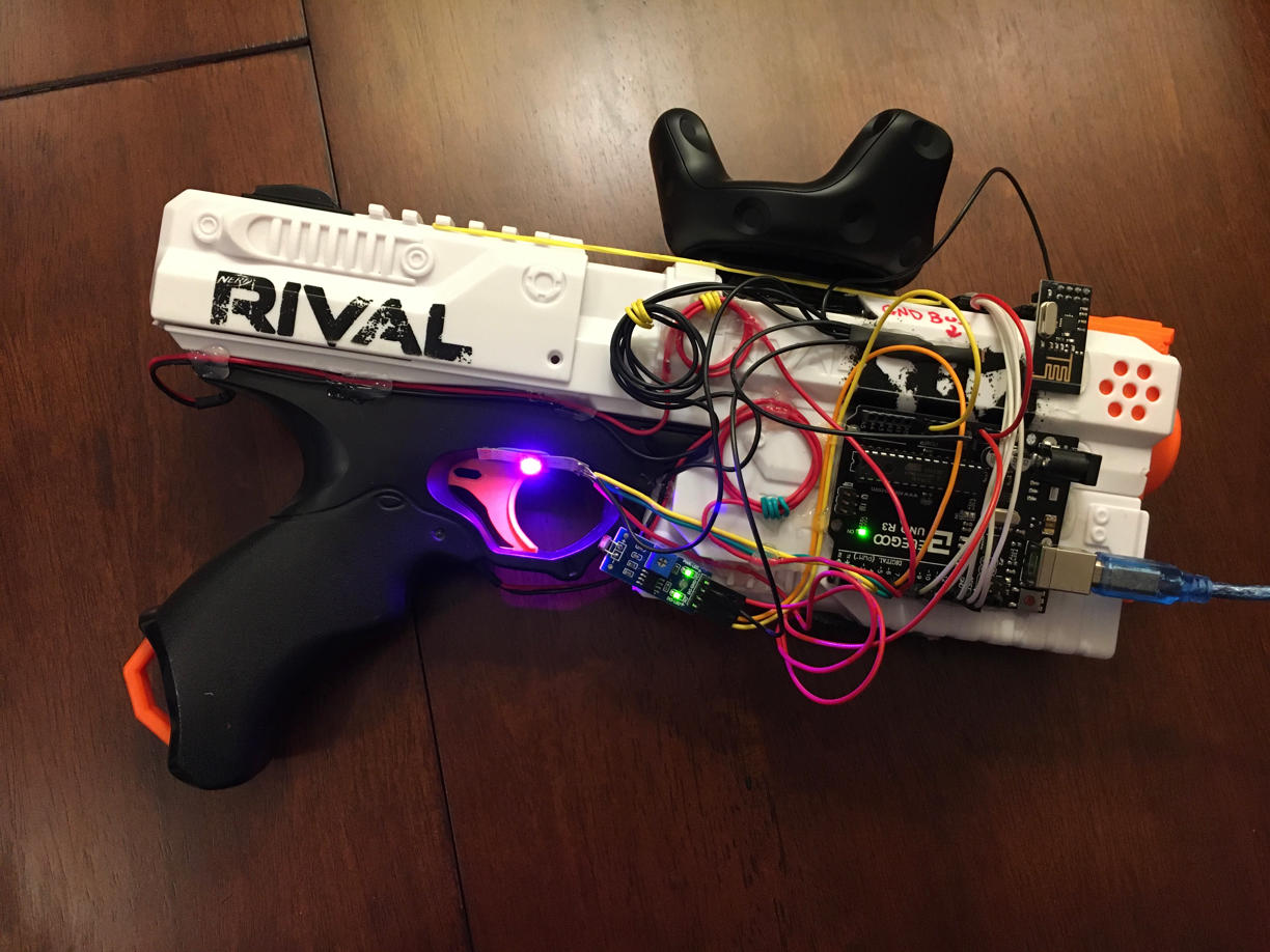 A nerf gun with a bunch of wires and a purple light near the trigger.
